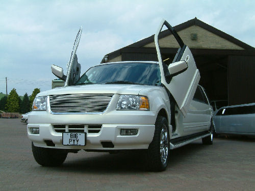 Chauffeur stretch white Ford Excursion 4x4 limousine hire with Lamborghini doors in Sheffield, Rotherham, Barnsley, Doncaster, Huddersfield, South Yorkshire