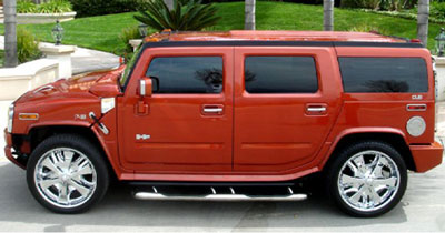 Chauffeur driven burnt orange Baby Hummer H2 hire in Liverpool, Manchester, Bolton, Warrington, North West