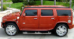 Chauffeur driven burnt orange Baby Hummer H2 hire in Liverpool, Manchester, Bolton, Warrington, North West
