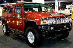 Chauffeur driven burnt orange Baby Hummer H2 hire in Manchester, Liverpool, Bolton, Warrington, North West