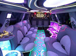 Chauffeur stretched pink Hummer H2 limousine hire interior in UK